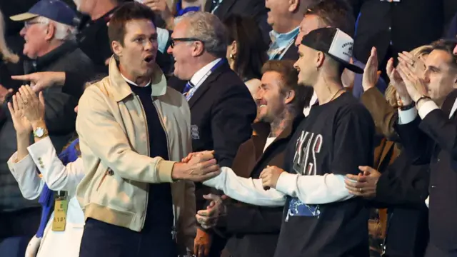 Birmingham City minority owner celebrates with David Beckham and Romeo Beckham after Jay Stansfield puts Blues 2-1 up against Wrexham.