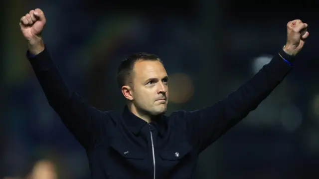 Birmingham City head coach Chris Davies raises two arms in the air to celebrate their win over Wexrham,