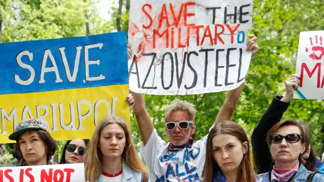 Ryan Wesley Routh holding banner saying 'Save the military of Azovsteel' surrounded by other people holding banners