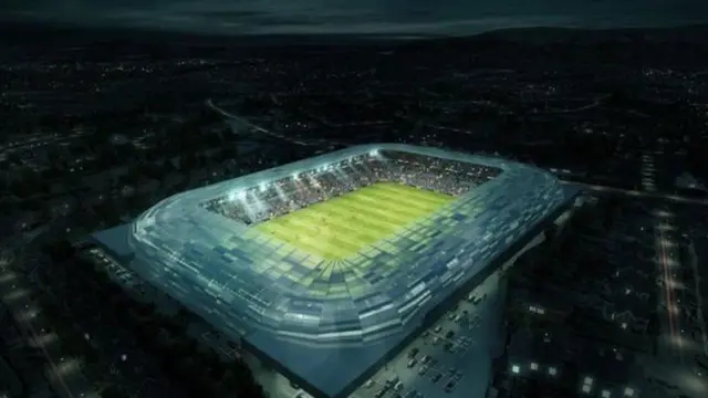 An artists' impression of Casement Park, with bright lights and a green stadium. Birds eye view.