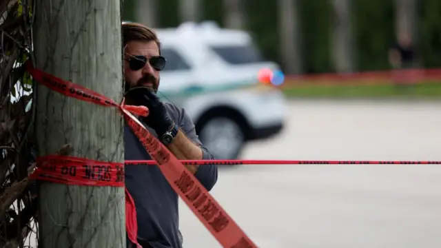 A law enforcement officer looks on after reports of shots fired at the Trump International Golf Course in West Palm Beach