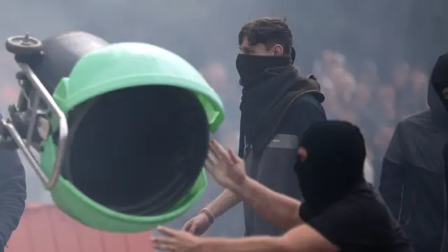 A man near a bin being thrown