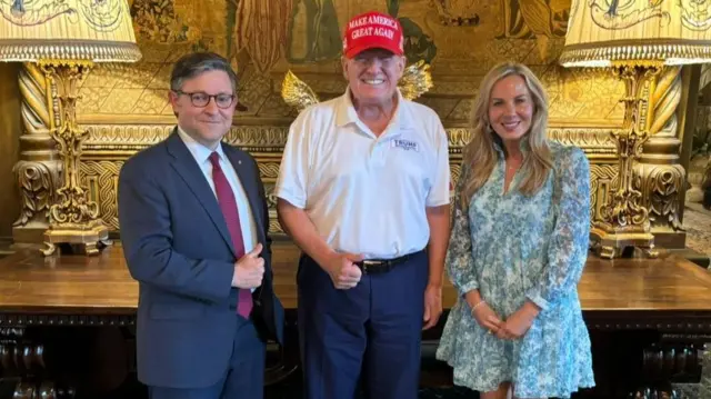 Mike Johnson and his wife Kelly with Donald Trump