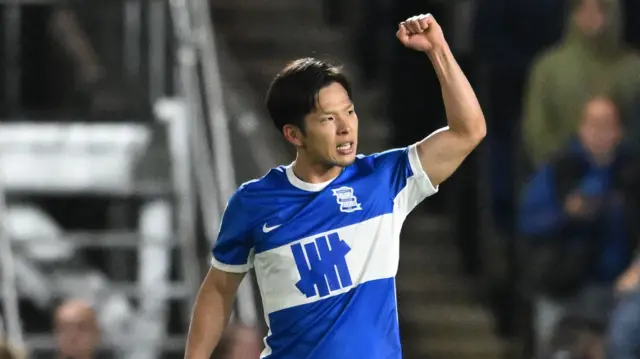 Birmingham City goalscorer Tomoki Iwata raises a fist in celebration.