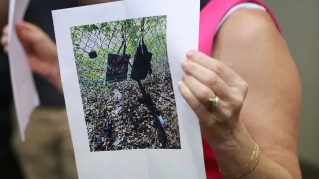 Palm Beach County Sheriff PIO Teri Barber holds a photograph of the rifle and other items found near where a suspect was discovered during a press conference regarding an apparent assassination attempt of former President Donald Trump on September 15, 2024, in West Palm Beach, Florida.