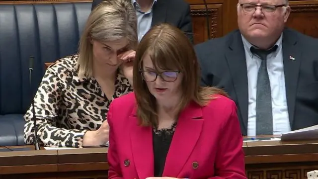 Caoimhe Archibald standing in the NI assembly chamber