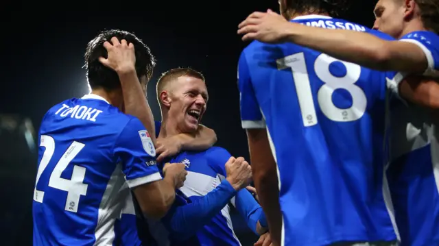 Birmingham City match-winner Jay Stansfield celebrates with teammates.