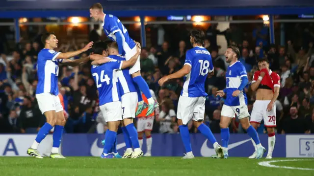 Tomoki Iwata is mobbed by teammates after scoring Birmingham City's third goal against Wrexham.