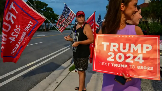 Supporters of Republican presidential nominee and former U.S. President Donald Trump gather around Mar-A-Lago waving Trump flags and holding a Trump 2024