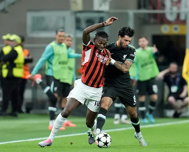 Rafael Leão of AC Milan and Dominik Szoboszlai of Liverpool FC battle for the ball