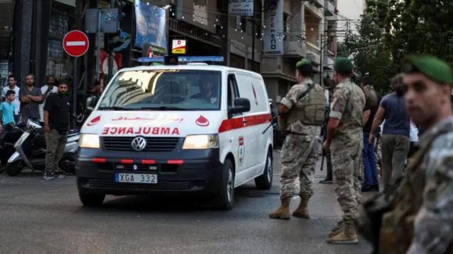 An ambulance passes solider on its way to the hospital