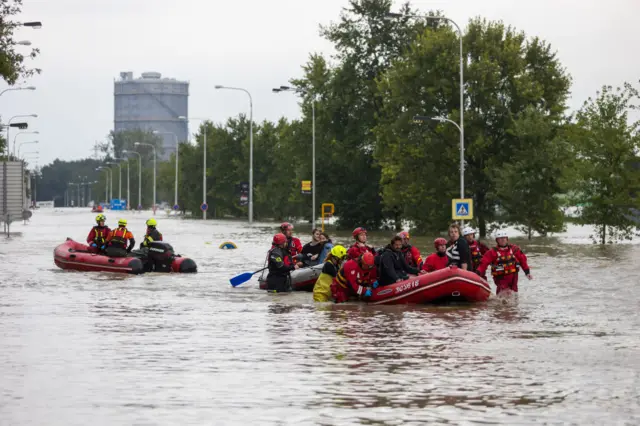 Emergency rescue workers evacuating residents