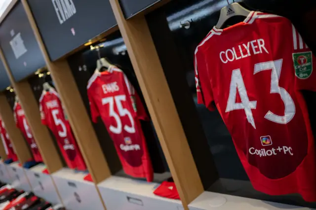 The Manchester United dressing room with shirts hung up