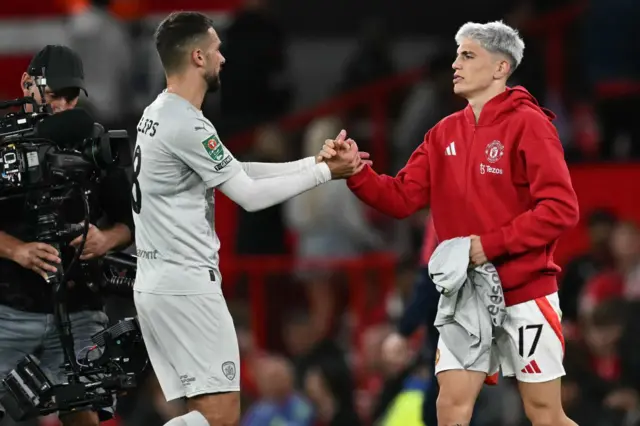 Garnacho shakes hands with Adam Phillips post match