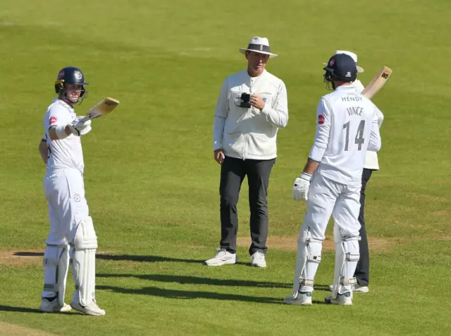 James Vince confers with the umpires before he is given out