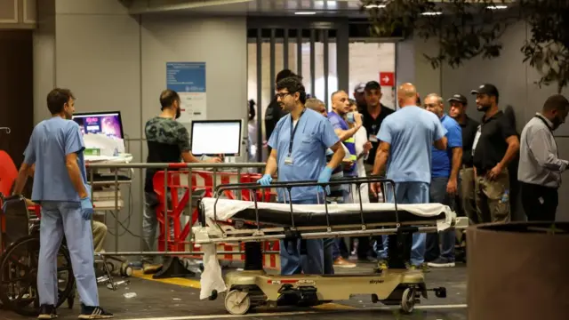 Medics work outside the entrance to a hospital