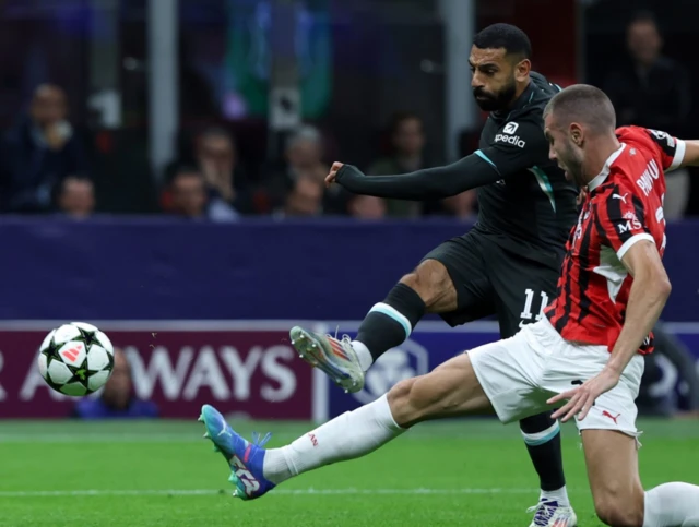 Mohamed Salah (right) and AC Milan’s Aleksandar Pavlović battle for the ball