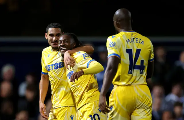 Eze smiles with team mates after his goal