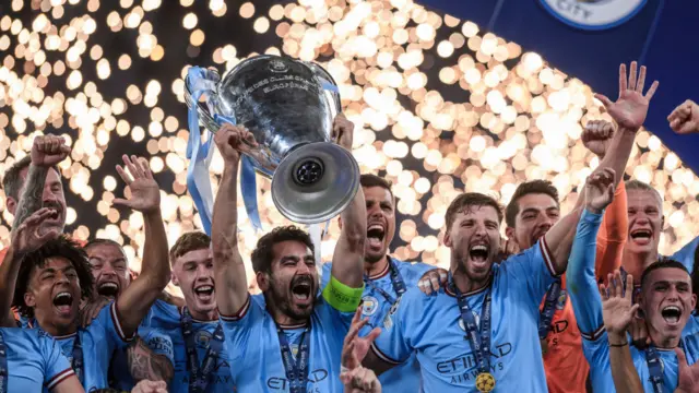 Rodri cheers as Manchester City team-mate Ilkay Gundogan lifts the trophy