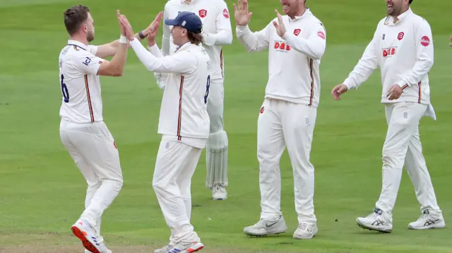 Sam Cook celebrates the wicket of Hamza Shaikh