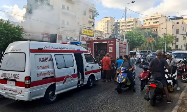 Smoke rises near a mobile shop in Sidon, located on the Mediterranean coast in south Lebanon