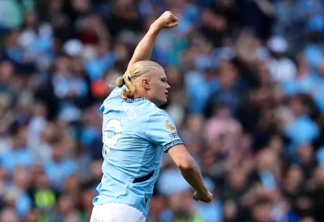 Haaland celebrates his goal by shaking his fist in the air