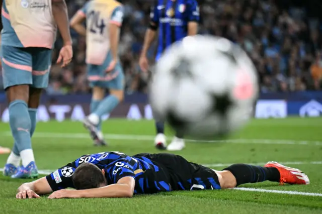 Augusto lies face down on the floor after seeing his shot saved