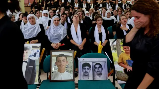 Women grieve for the children and teens killed at a soccer pitch by a rocket Israel says was fired from Lebanon, in Majdal Shams, a Druze village in the Israeli-occupied Golan Heights, July 29,