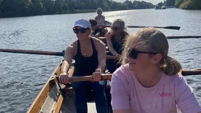 A close shot of a group of rowers in a boat