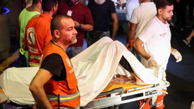 A victim on a stretcher outside the American University of Beirut Medical Center yesterday