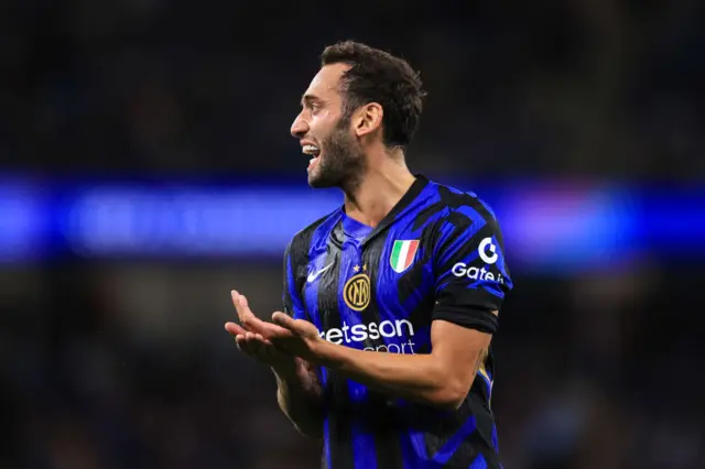 Calhanoglu applauds a pass