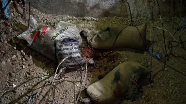 Four sacks - two which look like sandbags - at the bottom of a hole left by the Lebanese army