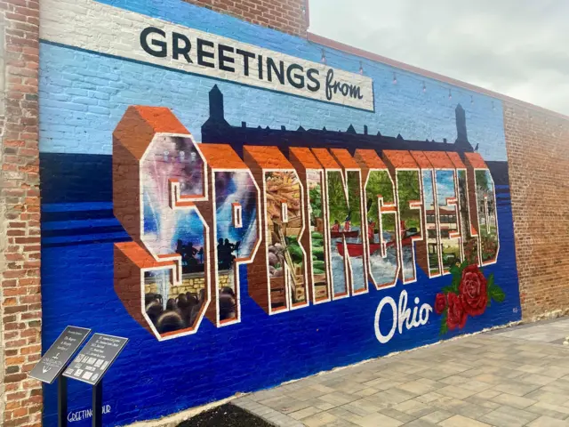 A mural reading "greetings from Springfield, Ohio"