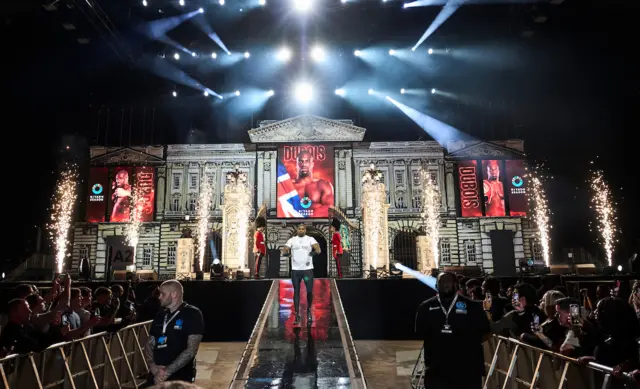 Daniel Dubois walks down a ramp with a makeshift Buckingham Palace in the background