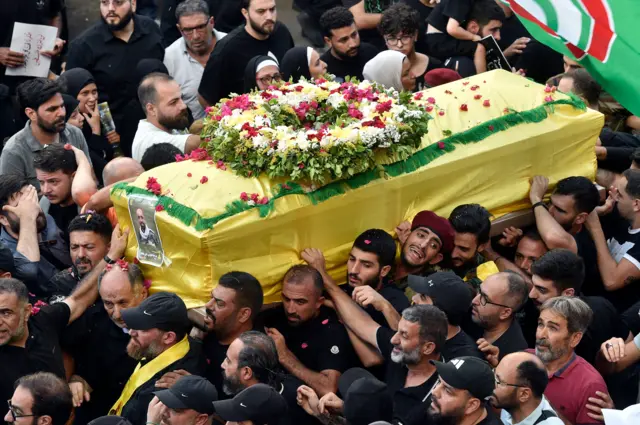 Men carry the coffin of one of those killed in the attacks