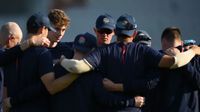 Lancashire team huddle before the start of play