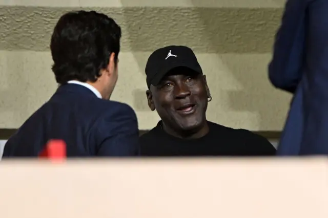 Basketball icon Michael Jordan sits in the stands in Monaco