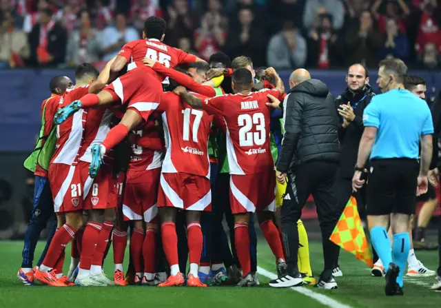 Brest's players huddle in celebration after their opening goal