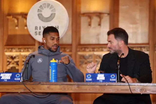 Anthony Joshua bumps fists with Eddie Hearn