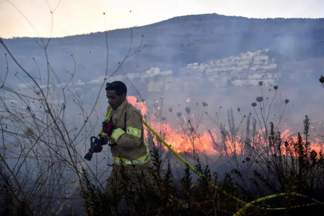 A firefighter in Kiryat Shmona, northern Israel, after rocket fire from Lebanon yesterday