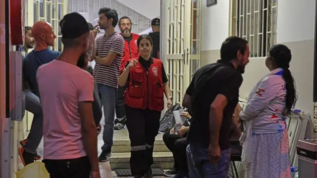 Lebanese people arrive at Red Cross building in Beirut to donate blood following call of Lebanon's Health Ministry