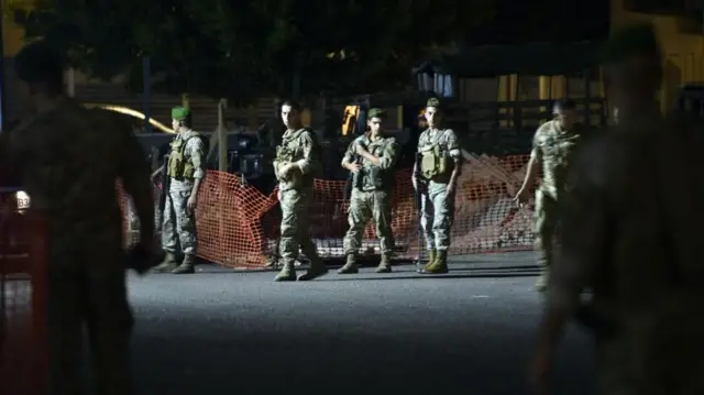 Lebanese soldiers prepare to blow up a communication device in a hospital car park in Beirut last night