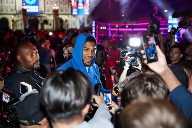 Anthony Joshua stands in front of fans