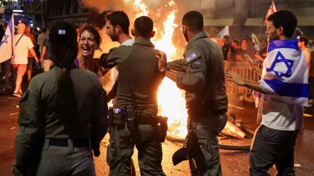 A person reacts as protesters rally against the government in Tel Aviv