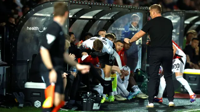 Joe Tomlinson falls into the Salford dugout