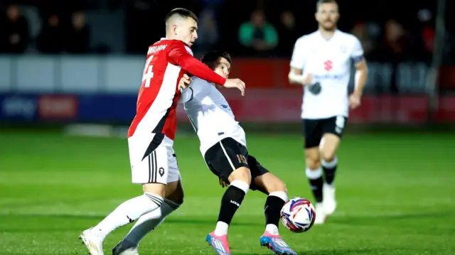 Ben Woodburn challenges for the ball