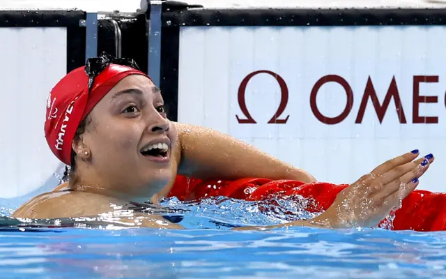 Grace Harvey looks up at the big screen after winning Paralympic gold