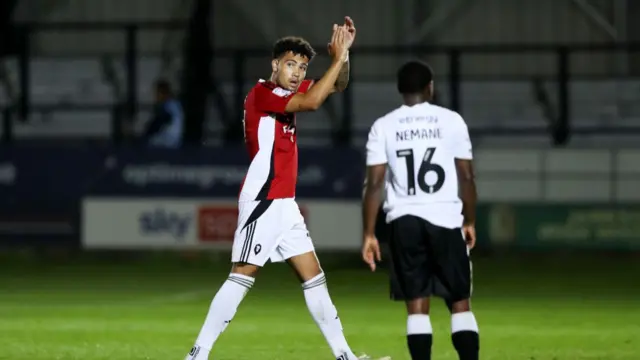 Frankie Okoronkwo applauds as he walks off the pitch