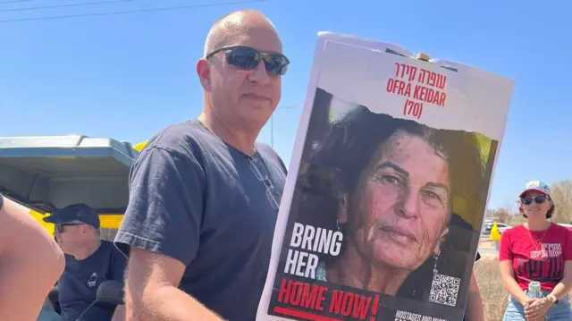 Protester holds up sign with hostage