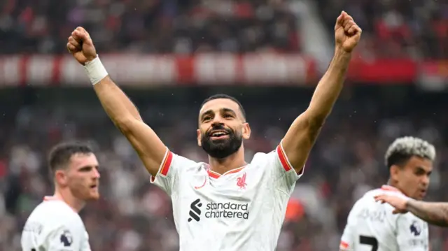 Mohamed Salah raises his arms in celebration towards the Liverpool fans at Old Trafford